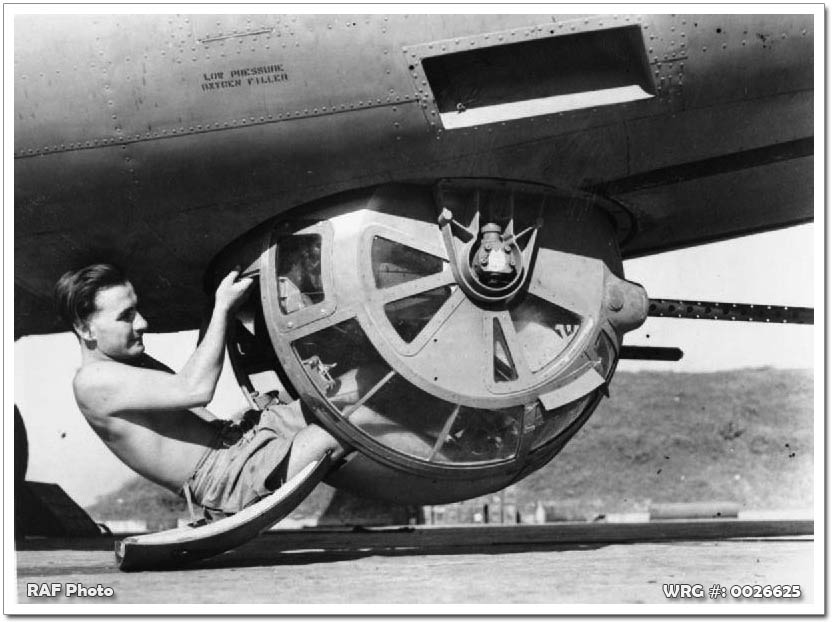 A crewman poses with the Sperry ball turret of a Royal Air Force B-24, Burma, c.1943-1945