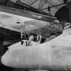 The tail assembly for a North American B-25 bomber is lowered into place from an overhead crane on the final assembly floor. WRG-0021572